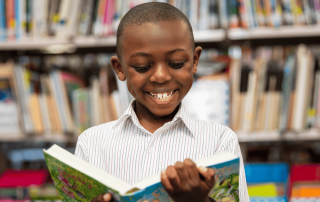 A photo of a St Therese's Catholic Primary School Lakemba student reading in the school library and on their way to 2025 NAPLAN results success